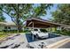 Convenient carport area showcasing covered parking and mature trees for shade and appeal at 70 Ashley Ln, Oldsmar, FL 34677