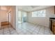 Open dining area with tile flooring, natural light, and sliding glass doors at 70 Ashley Ln, Oldsmar, FL 34677