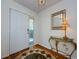 The entryway features hardwood floors, a decorative rug, and a console table with mirror at 70 Ashley Ln, Oldsmar, FL 34677