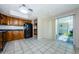 Kitchen with tile floors, wood cabinets, black appliances and sliding door to patio at 70 Ashley Ln, Oldsmar, FL 34677