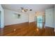 This spacious living room features hard wood floors and sliding glass doors leading to a screened in porch at 70 Ashley Ln, Oldsmar, FL 34677