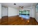 The spacious living room features wood floors, a closet, and a sliding glass door to the outside porch at 70 Ashley Ln, Oldsmar, FL 34677