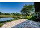 Brick patio with a view of a pond and lush green golf course on a sunny day at 70 Ashley Ln, Oldsmar, FL 34677