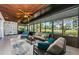 Bright sunroom with large windows, ceiling fans, and views of the golf course and pond at 70 Ashley Ln, Oldsmar, FL 34677
