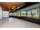 Open sunroom space featuring tile flooring and expansive golf course and pond views at 70 Ashley Ln, Oldsmar, FL 34677