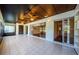 Enclosed sunroom featuring tile flooring, ceiling fans, and golf course views at 70 Ashley Ln, Oldsmar, FL 34677
