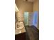 The bathroom has a double sink vanity and an entrance to the shower at 7530 Red Mill Cir, New Port Richey, FL 34653