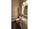 Bathroom features a granite vanity with a storage cabinet and decorative mirror at 7530 Red Mill Cir, New Port Richey, FL 34653
