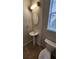 The powder room offers a pedestal sink, oval mirror and modern lighting at 7530 Red Mill Cir, New Port Richey, FL 34653