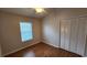 Simple bedroom features a ceiling fan, laminate floors, and ample closet space at 7530 Red Mill Cir, New Port Richey, FL 34653