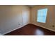 Bedroom showcasing wood laminate flooring and closet space at 7530 Red Mill Cir, New Port Richey, FL 34653