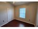 Bedroom featuring a closet, laminate flooring, and a bright window at 7530 Red Mill Cir, New Port Richey, FL 34653