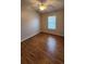 Bright bedroom featuring hardwood floors and a ceiling fan at 7530 Red Mill Cir, New Port Richey, FL 34653