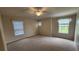 Neutral bedroom with wall-to-wall carpet and three windows at 7530 Red Mill Cir, New Port Richey, FL 34653