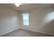 This bedroom has carpet, a ceiling fan and one window at 7530 Red Mill Cir, New Port Richey, FL 34653