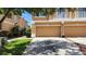 Charming townhouse showcasing an attached garage, lush lawn, and mature landscaping at 7530 Red Mill Cir, New Port Richey, FL 34653