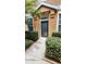 Inviting front entrance with a well-maintained garden and pathway leading to the front door at 7530 Red Mill Cir, New Port Richey, FL 34653