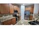 Kitchen featuring stainless steel appliances, granite countertops, tile backsplash and ample cabinet space at 7530 Red Mill Cir, New Port Richey, FL 34653