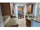Updated kitchen featuring stainless steel refrigerator, granite countertops, and tile backsplash at 7530 Red Mill Cir, New Port Richey, FL 34653