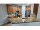 Granite countertops accent this kitchen with stainless steel appliances and wooden cabinets at 7530 Red Mill Cir, New Port Richey, FL 34653