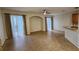 Spacious living room with sliding glass door, and breakfast bar seating from adjacent kitchen at 7530 Red Mill Cir, New Port Richey, FL 34653
