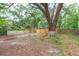 A fenced backyard with mature trees offers shade and privacy at 8008 N Alaska St, Tampa, FL 33604