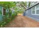 View of home's exterior, yard, and fence at 8008 N Alaska St, Tampa, FL 33604