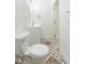 Bathroom with white cabinets, a toilet and patterned tile flooring at 8008 N Alaska St, Tampa, FL 33604