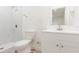 Well-lit bathroom with a tiled shower, white vanity, and a classic toilet at 8008 N Alaska St, Tampa, FL 33604