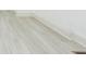 Close up of white hardwood flooring with a vent in the corner at 8008 N Alaska St, Tampa, FL 33604