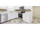 Modern kitchen featuring stainless appliances, quartz countertops, and unique tile floor at 8008 N Alaska St, Tampa, FL 33604