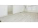Spacious living room with a new light wood floor and an attractive front door at 8008 N Alaska St, Tampa, FL 33604