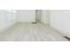 Bright living room showcasing a new wood floor, white walls, and minimalist design at 8008 N Alaska St, Tampa, FL 33604