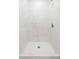 Modern shower features sleek, large white marble tiles, adding a touch of elegance at 8008 N Alaska St, Tampa, FL 33604