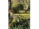 Charming garden view with a comfortable bench seat nestled among colorful flowers and lush greenery at 8120 Greenbrier Ct, Spring Hill, FL 34606