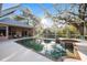Screened-in pool with attached hot tub, patio, and landscaping at 8120 Greenbrier Ct, Spring Hill, FL 34606