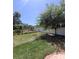Spacious backyard featuring lush green grass, mature tree, and full fence, perfect for outdoor activities at 824 Greenbelt Cir, Brandon, FL 33510
