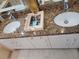 Granite countertop with double sinks and magazine rack in this modern Primary bathroom at 824 Greenbelt Cir, Brandon, FL 33510