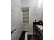 Well-organized bathroom with a built-in storage shelf, sleek black countertop, and modern fixtures at 824 Greenbelt Cir, Brandon, FL 33510