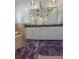 Bathroom featuring a double sink vanity with brown granite and modern lighting fixtures at 824 Greenbelt Cir, Brandon, FL 33510