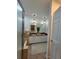 Bathroom featuring dual sinks, granite countertops, decorative lighting, and a glass enclosed shower at 824 Greenbelt Cir, Brandon, FL 33510
