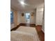 Bedroom with hardwood floors, a plush rug, and an ensuite bathroom for a private retreat at 824 Greenbelt Cir, Brandon, FL 33510