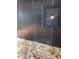 Close-up of sleek herringbone backsplash with outlet over speckled granite countertop at 824 Greenbelt Cir, Brandon, FL 33510