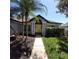 Charming home featuring a bright yellow front door flanked by white columns and a well-manicured lawn at 824 Greenbelt Cir, Brandon, FL 33510