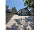 A large, two-car garage is accessible from the long driveway bordered by a privacy fence at 824 Greenbelt Cir, Brandon, FL 33510