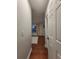 Hallway view leads to a sunlit living area with hardwood floors and a neutral rug at 824 Greenbelt Cir, Brandon, FL 33510