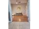 Hallway with hard wood floors and a sitting bench with accent pillows at 824 Greenbelt Cir, Brandon, FL 33510