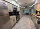 Well-lit kitchen with stainless steel appliances, granite countertops, and dining area in view at 824 Greenbelt Cir, Brandon, FL 33510