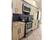 Functional kitchen featuring stainless steel oven, microwave, modern cabinets and tile flooring at 824 Greenbelt Cir, Brandon, FL 33510