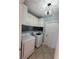 Bright laundry room with white cabinets, modern light fixture, and washer and dryer at 824 Greenbelt Cir, Brandon, FL 33510